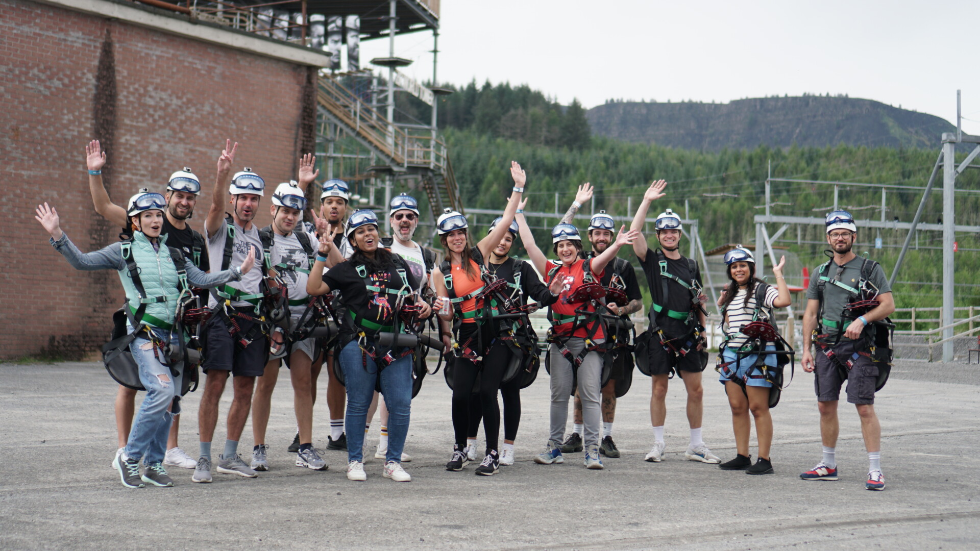 People cheering ziplining in wales on a team offsite in South Wales