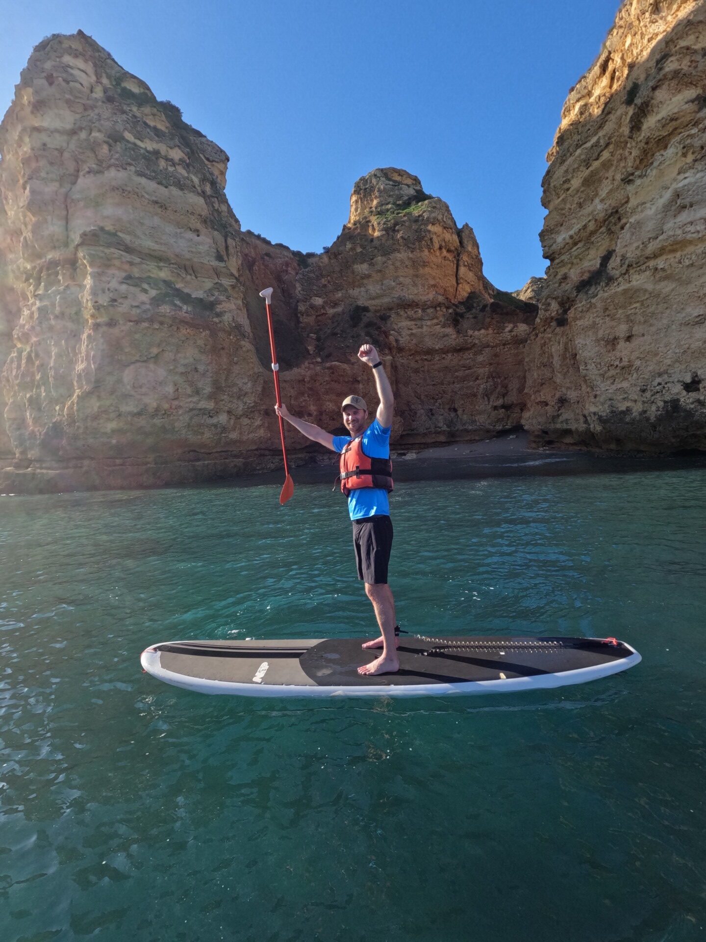 a man learning to paddleboard in algarve, portugal