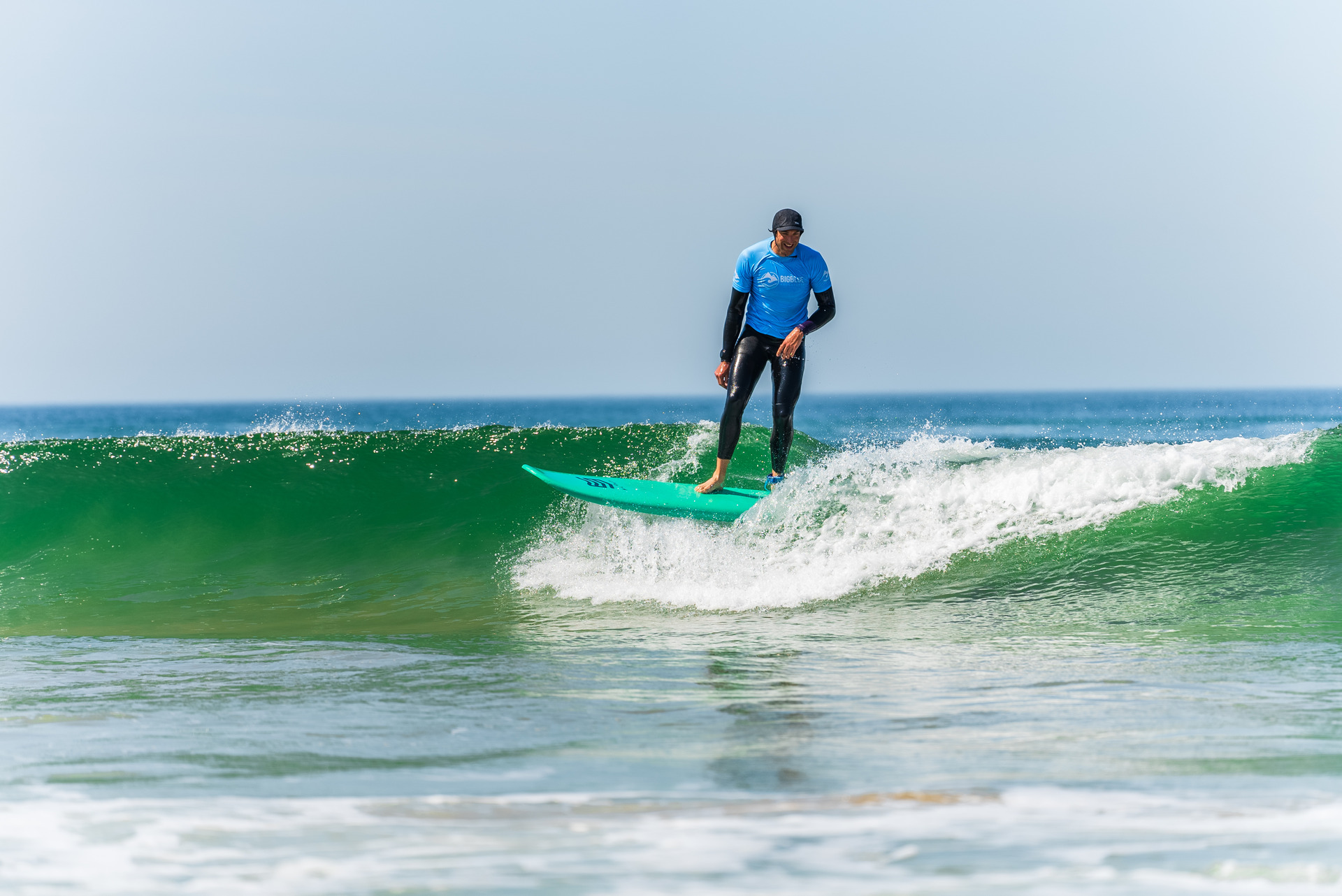 A man catching a wave while surfing in Costa da Caparica, Portugal